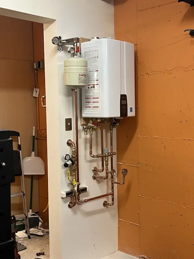 Plumbing technician inspecting water heater connections in Samsula-Spruce Creek